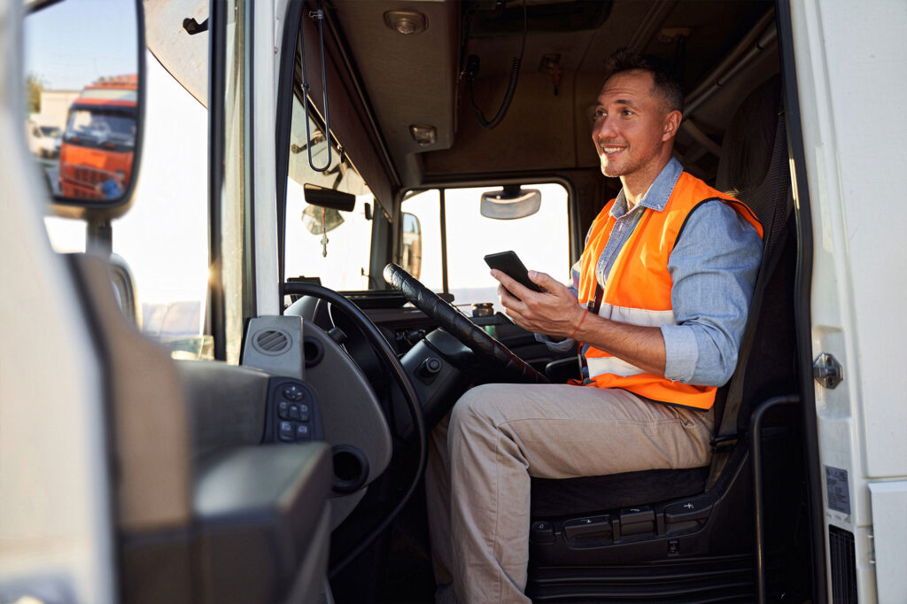 fleet truck driver holding a phone